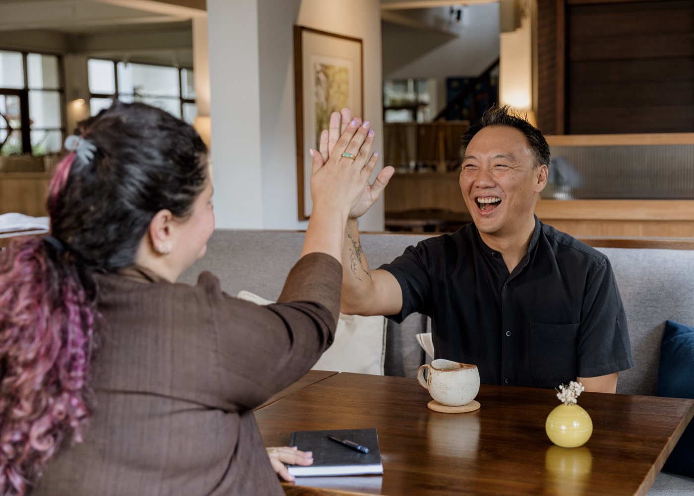 Mac Ling sharing a high-five with a client