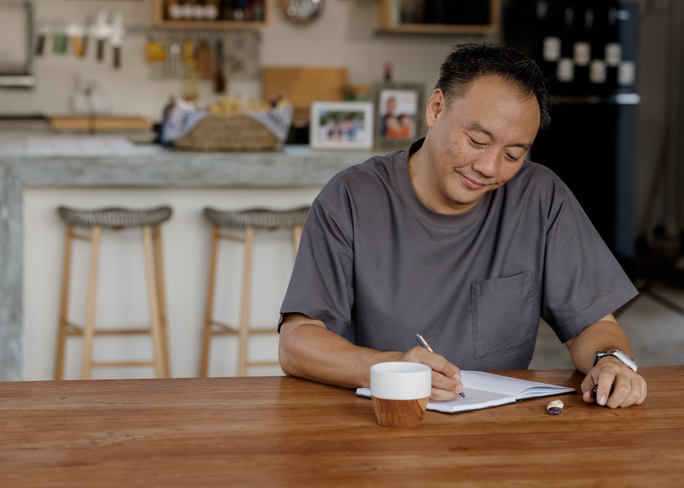 Mac Ling writing at the kitchen table